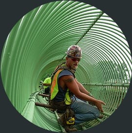 Whitacre Rebar team member installing green rebar structure